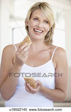 Mid Adult Woman Eating Fresh Brown Bread Roll View Large Photo Image Stock Photography - Mid Adult Woman Eating Fresh Brown Bread Roll. Fotosearch