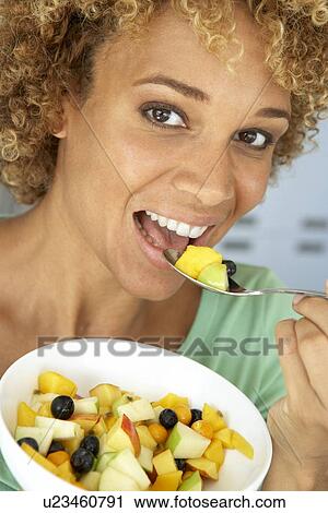 Mid Adult Woman Eating Fresh Fruit Salad View Large Photo Image Stock Image - Mid Adult Woman Eating Fresh Fruit Salad. Fotosearch