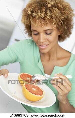 Mid Adult Woman Eating Fresh Grapefruit View Large Photo Image Stock Image - Mid Adult Woman Eating Fresh Grapefruit. Fotosearch