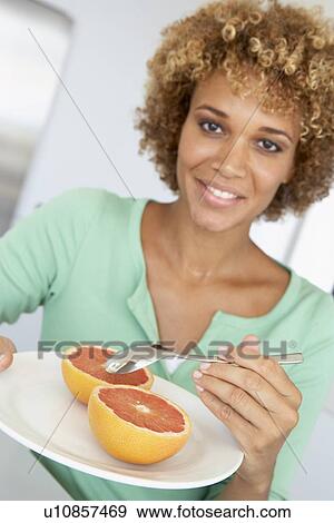 Mid Adult Woman Eating Fresh Grapefruit View Large Photo Image Stock Photo - Mid Adult Woman Eating Fresh Grapefruit. Fotosearch
