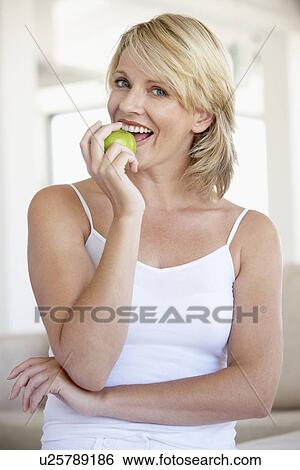 Mid Adult Woman Eating Green Apple View Large Photo Image Stock Photograph - Mid Adult Woman Eating Green Apple. Fotosearch