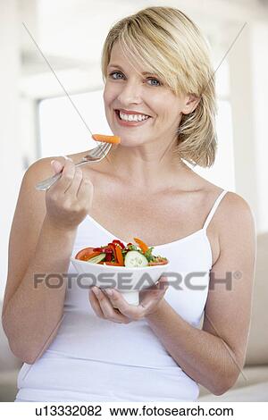 Mid Adult Woman Eating Salad View Large Photo Image Stock Image - Mid Adult Woman Eating Salad. Fotosearch
