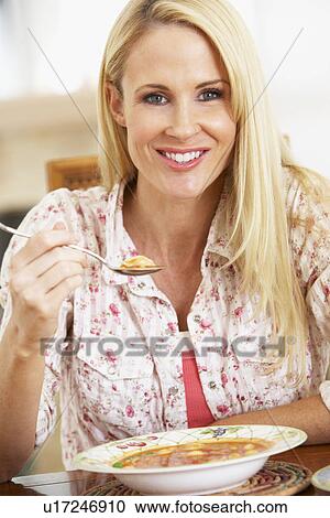 Mid Adult Woman Eating Soup, Smiling At The Camera View Large Photo Image Stock Image - Mid Adult Woman Eating Soup, Smiling At The Camera. Fotosearch
