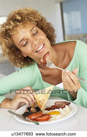 Mid Adult Woman Eating Unhealthy Fried Breakfast View Large Photo Image Stock Image - Mid Adult Woman Eating Unhealthy Fried Breakfast. Fotosearch