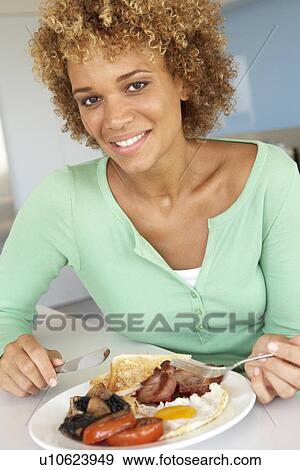 Mid Adult Woman Eating Unhealthy Fried Breakfast View Large Photo Image Stock Photo - Mid Adult Woman Eating Unhealthy Fried Breakfast. Fotosearch