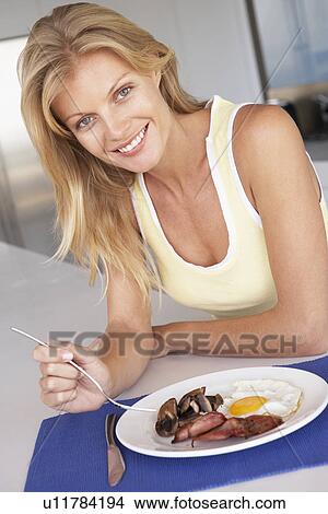 Mid Adult Woman Eating Unhealthy Breakfast View Large Photo Image Picture - Mid Adult Woman Eating Unhealthy Breakfast. Fotosearch