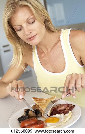 Mid Adult Woman Eating Unhealthy Breakfast View Large Photo Image Stock Photo - Mid Adult Woman Eating Unhealthy Breakfast. Fotosearch