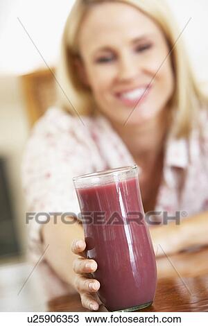 Mid Adult Woman Holding A Fresh Berry Smoothie View Large Photo Image Stock Image - Mid Adult Woman Holding A Fresh Berry Smoothie. Fotosearch