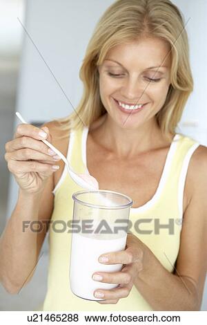 Mid Adult Woman Holding Dietary Supplements View Large Photo Image Stock Photo - Mid Adult Woman Holding Dietary Supplements. Fotosearch