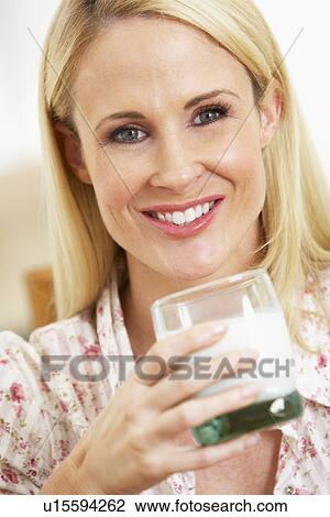 Mid Adult Woman Holding Glass Of Milk, Smiling At Camera View Large Photo Image Stock Image - Mid Adult Woman Holding Glass Of Milk, Smiling At Camera. Fotosearch