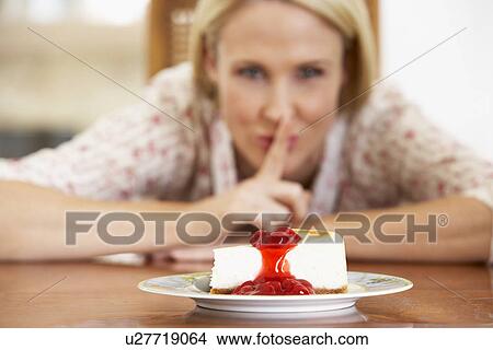 Picture - Mid Adult Woman Looking At Cheesecake. Fotosearch