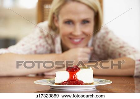 Mid Adult Woman Looking At Cheesecake View Large Photo Image Stock Photo - Mid Adult Woman Looking At Cheesecake. Fotosearch