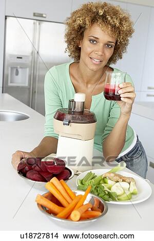 Mid Adult Woman Making Fresh Vegetable Juice View Large Photo Image Picture - Mid Adult Woman Making Fresh Vegetable Juice. Fotosearch