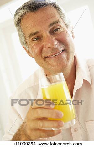 Middle Aged Man Drinking A Glass Of Orange Juice View Large Photo Image Picture - Middle Aged Man Drinking A Glass Of Orange Juice. Fotosearch