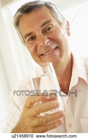 Middle Aged Man Drinking A Glass Of Water View Large Photo Image Stock Image - Middle Aged Man Drinking A Glass Of Water. Fotosearch