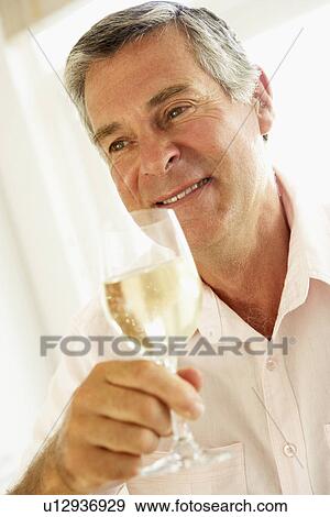 Stock Photo - Middle Aged Man Drinking A Glass Of Wine. Fotosearch