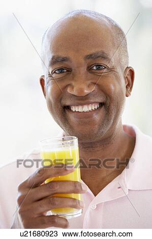 Middle Aged Man Drinking Fresh Orange Juice View Large Photo Image Stock Image - Middle Aged Man Drinking Fresh Orange Juice. Fotosearch