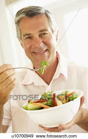 Middle Aged Man Eating A Healthy Salad View Large Photo Image Stock Photo - Middle Aged Man Eating A Healthy Salad. Fotosearch