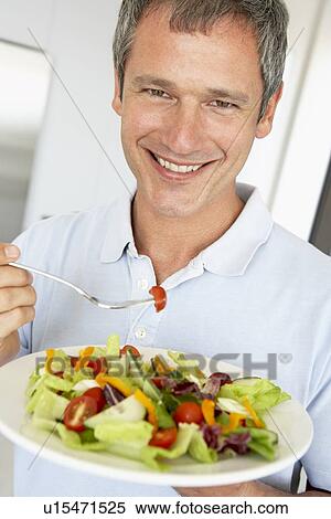 Stock Photography - Middle Aged Man Eating A Healthy Salad. Fotosearch