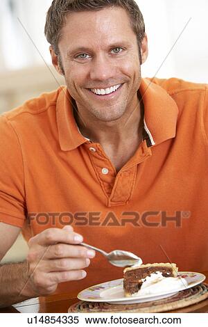 Stock Photography - Middle Aged Man Eating Chocolate Cake. Fotosearch