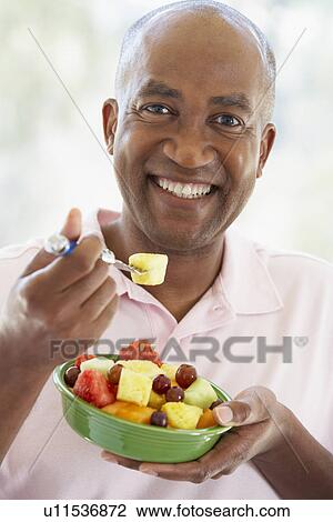 Middle Aged Man Eating Fresh Fruit Salad View Large Photo Image Stock Image - Middle Aged Man Eating Fresh Fruit Salad. Fotosearch