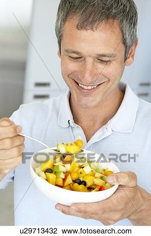 Middle Aged Man Eating Fresh Fruit Salad View Large Photo Image Stock Image - Middle Aged Man Eating Fresh Fruit Salad. Fotosearch