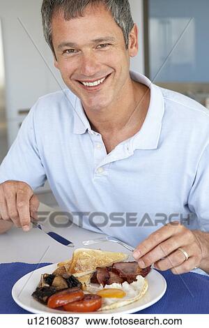Middle Aged Man Eating Unhealthy Fried Breakfast View Large Photo Image Stock Photo - Middle Aged Man Eating Unhealthy Fried Breakfast. Fotosearch