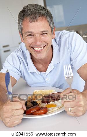 Middle Aged Man Eating Unhealthy Fried Breakfast View Large Photo Image Stock Photograph - Middle Aged Man Eating Unhealthy Fried Breakfast. Fotosearch
