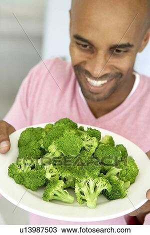 Middle Aged Man Holding A Plate Of Broccoli View Large Photo Image Stock Image - Middle Aged Man Holding A Plate Of Broccoli. Fotosearch