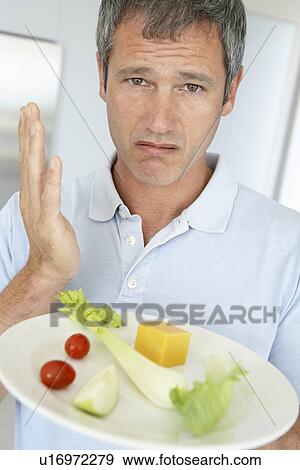 Middle Aged Man Holding A Plate Of Fresh And Healthy Food View Large Photo Image Stock Photo - Middle Aged Man Holding A Plate Of Fresh And Healthy Food. Fotosearch