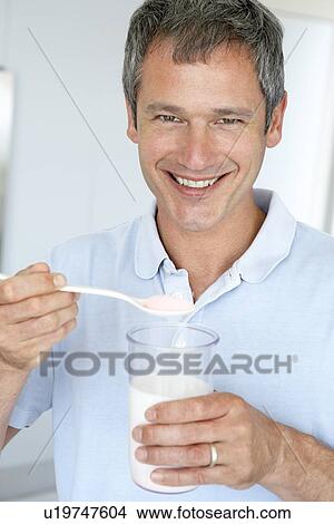 Middle Aged Man Holding Dietary Supplements View Large Photo Image Picture - Middle Aged Man Holding Dietary Supplements. Fotosearch