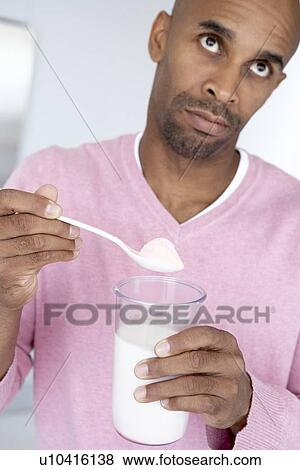 Middle Aged Man Holding Dietary Supplements View Large Photo Image Stock Photo - Middle Aged Man Holding Dietary Supplements. Fotosearch