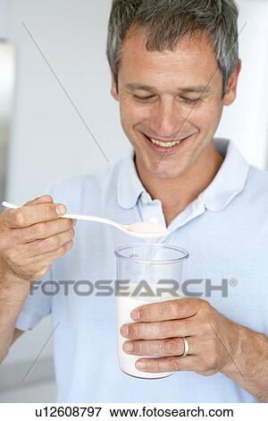 Middle Aged Man Preparing A Dietary Supplement View Large Photo Image Stock Photo - Middle Aged Man Preparing A Dietary Supplement. Fotosearch