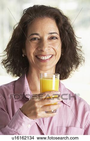 Middle Aged Woman Drinking Fresh Orange Juice View Large Photo Image Picture - Middle Aged Woman Drinking Fresh Orange Juice. Fotosearch