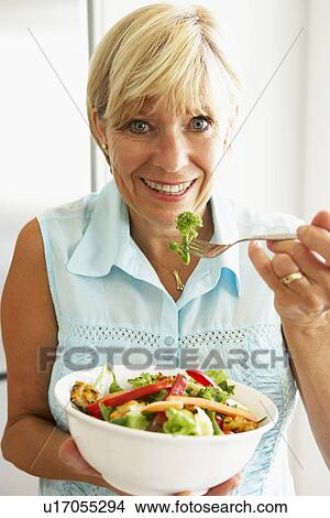 Middle Aged Woman Eating A Healthy Salad View Large Photo Image Picture - Middle Aged Woman Eating A Healthy Salad. Fotosearch