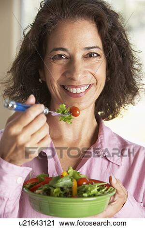 Middle Aged Woman Eating A Salad View Large Photo Image Stock Image - Middle Aged Woman Eating A Salad. Fotosearch