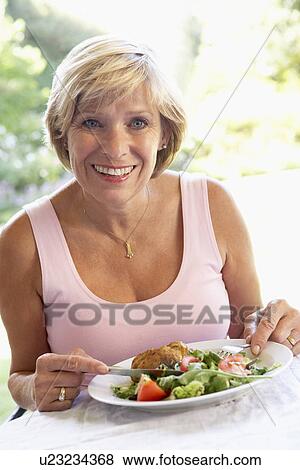 Middle Aged Woman Eating An Al Fresco Lunch View Large Photo Image Stock Photo - Middle Aged Woman Eating An Al Fresco Lunch. Fotosearch