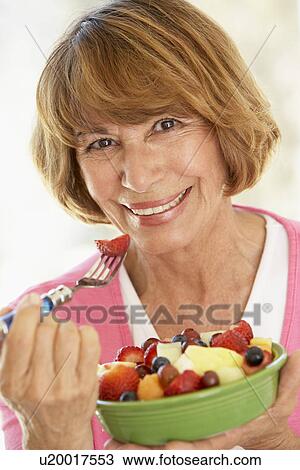 Middle Aged Woman Eating Fresh Fruit Salad View Large Photo Image Stock Image - Middle Aged Woman Eating Fresh Fruit Salad. Fotosearch