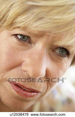 Stock Photo - Middle Aged Woman Looking Anxious. Fotosearch