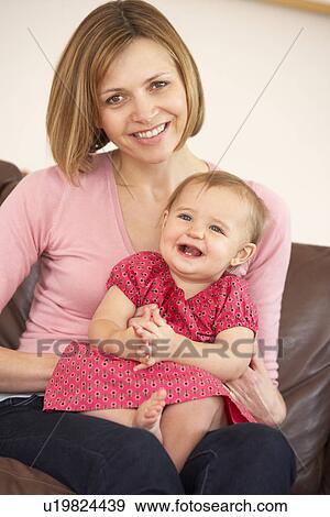 Mother And Baby Daughter On Sofa View Large Photo Image Stock Photo - Mother And Baby Daughter On Sofa. Fotosearch