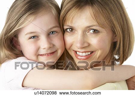 Stock Photo - Mother And Daughter Smiling And Hugging. Fotosearch