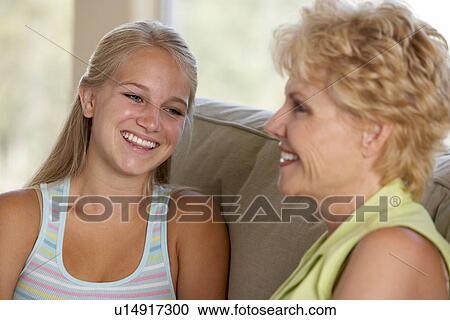 Stock Image - Mother And Daughter Together At Home. Fotosearch