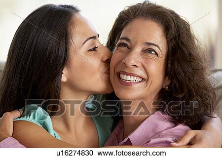 Stock Image - Mother And Daughter Together At Home. Fotosearch