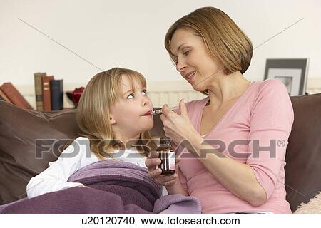 Mother Giving Medicine To Sick Daughter View Large Photo Image Stock Image - Mother Giving Medicine To Sick Daughter. Fotosearch