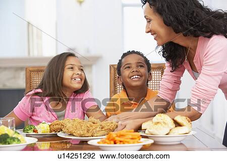 Mother Serving A Meal To Her Children At Home View Large Photo Image Stock Image - Mother Serving A Meal To Her Children At Home. Fotosearch