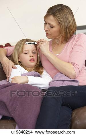 Picture - Mother Taking Temperature Of Sick Daughter. Fotosearch