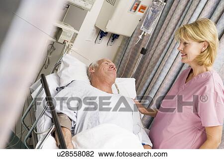 Stock Image - Nurse Caring For Patient. Fotosearch