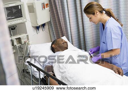 Stock Photo - Nurse Caring For Patient. Fotosearch