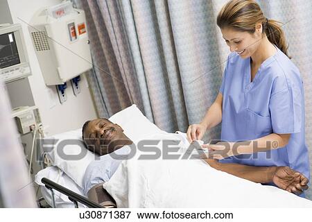 Stock Photo - Nurse Caring For Patient. Fotosearch