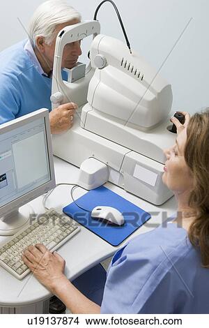 Picture - Nurse Checking Patient's Eyes. Fotosearch